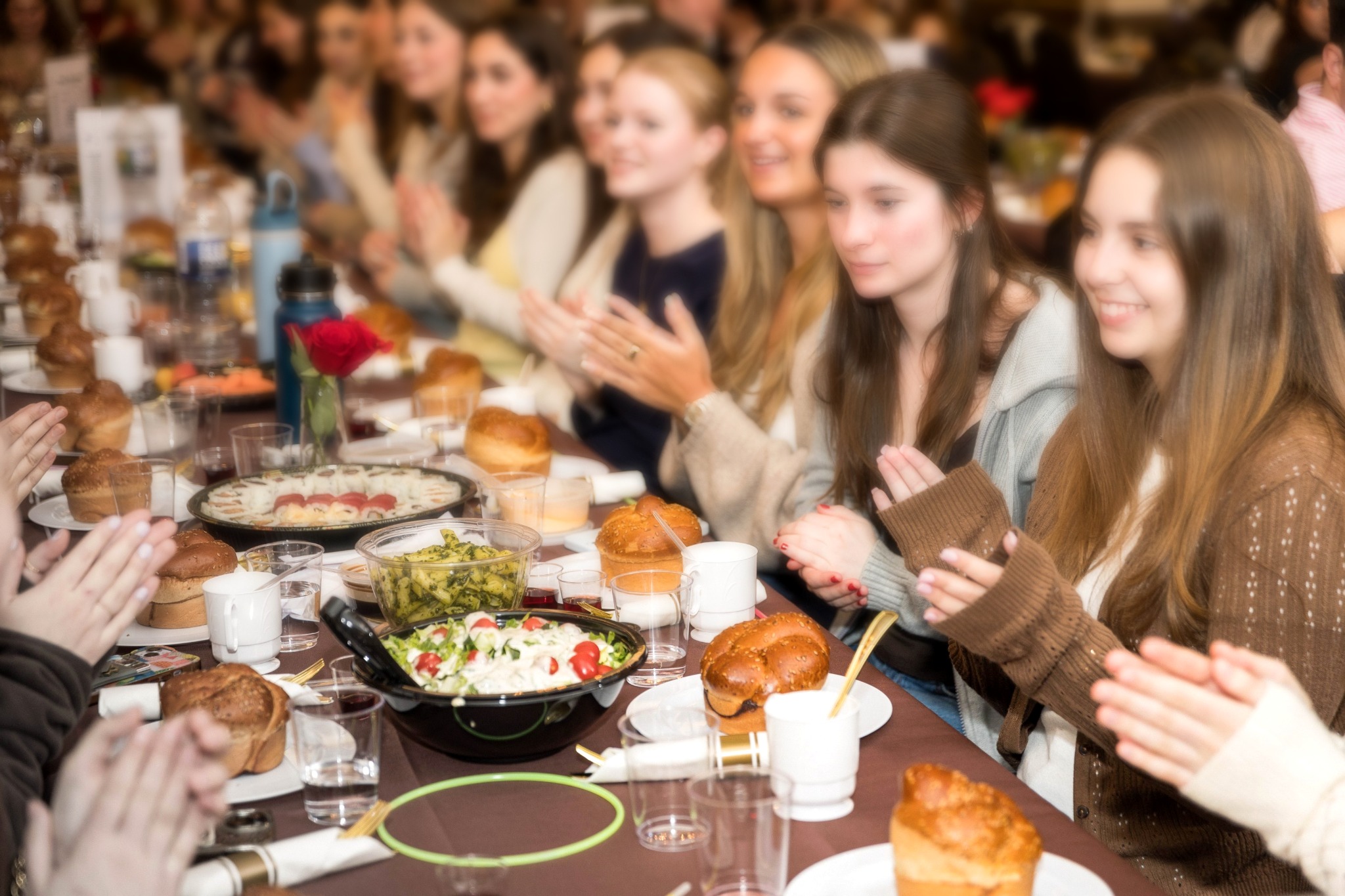 Shabbat meal with young women gathered around a table